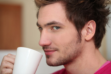 Man drinking from coffee mug
