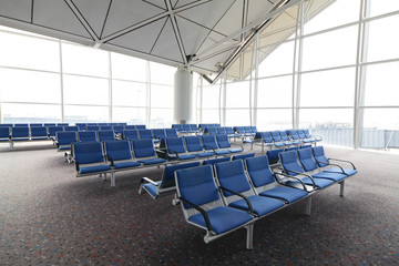 row of blue chair at airport in Hongkong