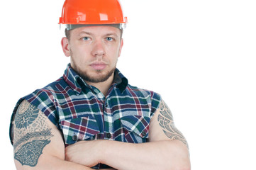 Confident tattooed building contractor with his arms crossed