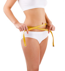 Woman measuring her slim body isolated on white