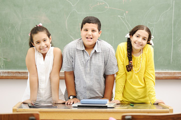 Happy children in classroom, school