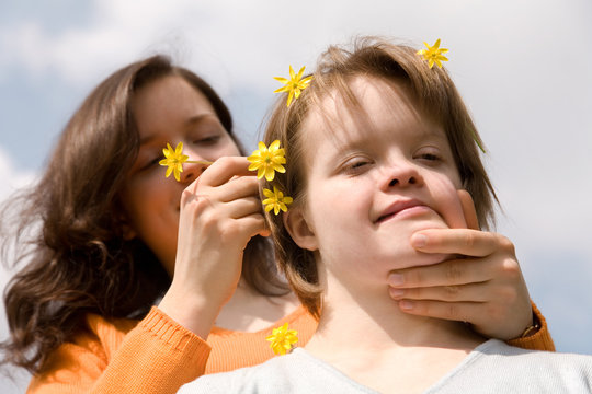 A girl with Down syndrome and her sister.
