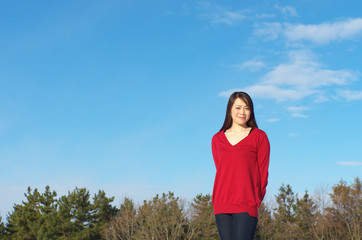 Asian woman agarinst clear sky