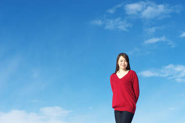 Fototapeta na wymiar Asian woman agarinst clear sky