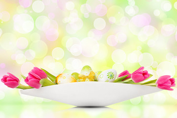 tulips and easter eggs before abstract bokeh light background
