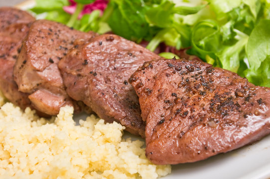 Tenderloin steaks in wine sauce with cadamon and kuskus groats