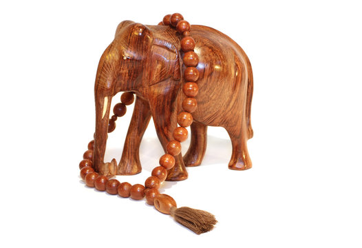 A wooden elephant and wooden beeds