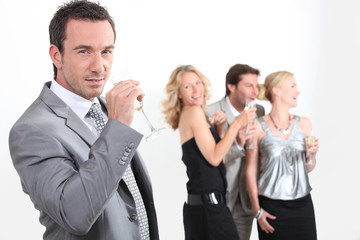 Four young professionals drinking champagne