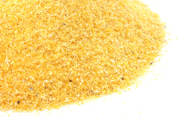 Yellow corn flour scattered on white background