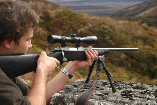 hunter aiming rifle