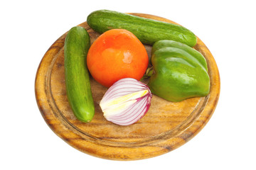 Pepper, onion, cucumber and tomato on a desk