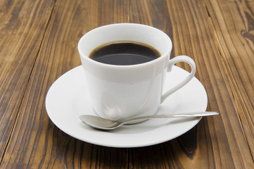 Fototapeta na wymiar Się z filiżanki kawy na drewnianym stole