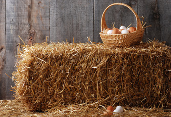Basket of eggs on hay bale