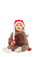 Portrait of cute baby in Santa hat looking up