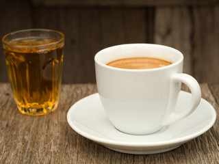 Side view White ceramic Cup of coffee and glass of tea
