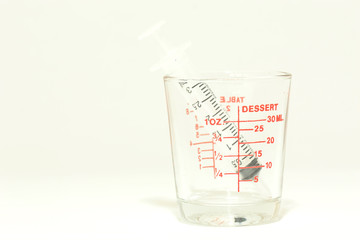 Glass measuring cup isolated on white background .