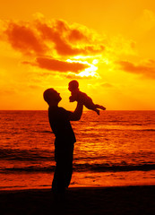 father with little baby on the sea