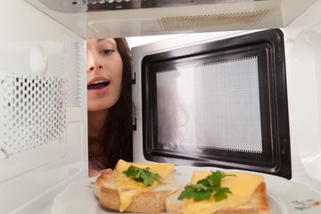 Girl open a microwave