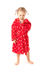 Girl in dressing-gown with toothbrush in hand