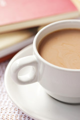 Cup of coffee and books