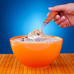woman holding a spoon with cereal