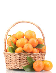 tangerines with leaves in a beautiful basket isolated on white