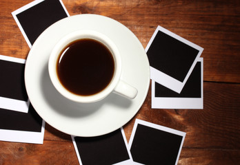 Photo papers with coffee on wooden background