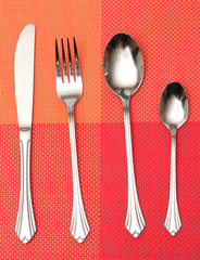 Fork, spoon and knife in a red cloth