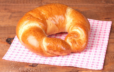 Bagel on napkin on wooden table