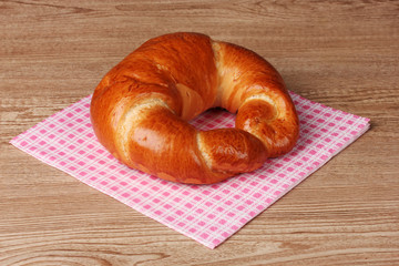 Bagel on napkin on wooden table