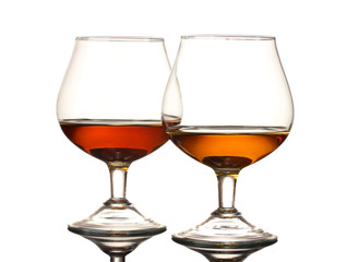 Two glasses of cognac on grey background