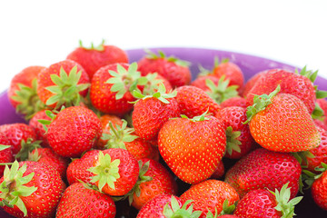 strawberries in a glass plate isolated on white