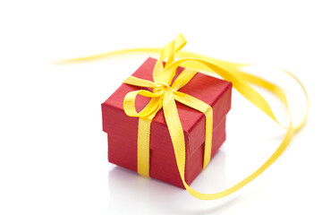 red gift box with a yellow ribbon isolated on white