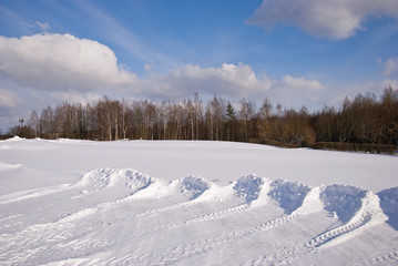 Snow pushed into piles in the park winter backdrop