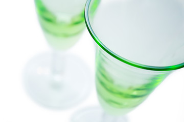 Transparent green glasses on white background