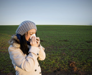 Woman blowing nose