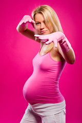 Pregnant woman in rubber gloves indoors