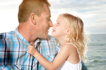 Fototapeta premium Father and daughter enjoy sunny day at the beach.