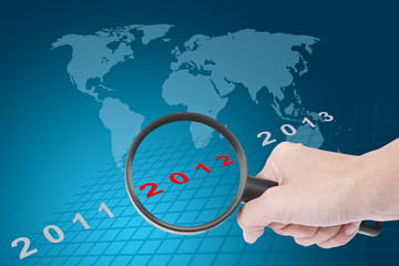 hand searching new year 2012 with world map