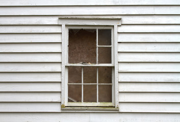 Fototapeta na wymiar Broken and Boarded Window from Abandoned House