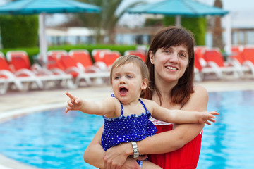 Fototapeta na wymiar happy mother with toddler at resort