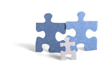Three figures from puzzle, father, mother and child