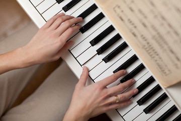 Playing Piano (shallow DOF; color toned image)