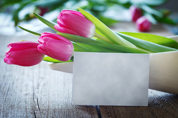 tulips in bowl on wooden board with copyspace