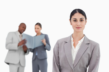 Saleswoman with colleagues behind her