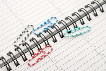 clips scattered on a notebook