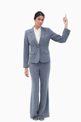 Businesswoman pointing upwards