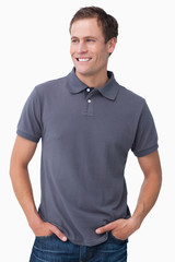 Smiling male with hands in his pockets