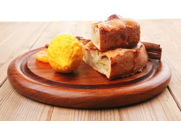 apple cake served with lemon and cinnamon