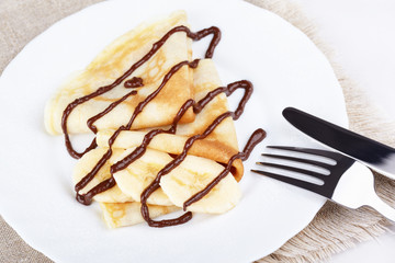 Thin pancakes with banana and chocolate